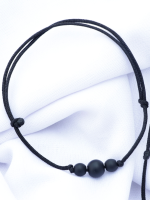 Handcrafted matte onyx stone bracelet and necklace set with 8mm and 6mm beads on an adjustable black cord, displayed on a fabric background.