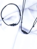 Handcrafted matte onyx stone bracelet and necklace set with 8mm and 6mm beads on an adjustable black cord, displayed on a fabric background.