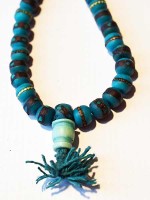 White bone mala, inlaid with turquoise and coral powder, as well as copper.