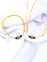 Handcrafted Rudraksha seed bracelet and necklace set with matte onyx and rudraksha beads on an adjustable black cord, displayed on a fabric background.