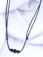 Handcrafted matte onyx stone bracelet and necklace set with 8mm and 6mm beads on an adjustable black cord, displayed on a fabric background.