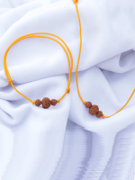 Handcrafted Rudraksha seed bracelet and necklace set with 8mm and 6mm beads on an adjustable black cord, displayed on a fabric background.